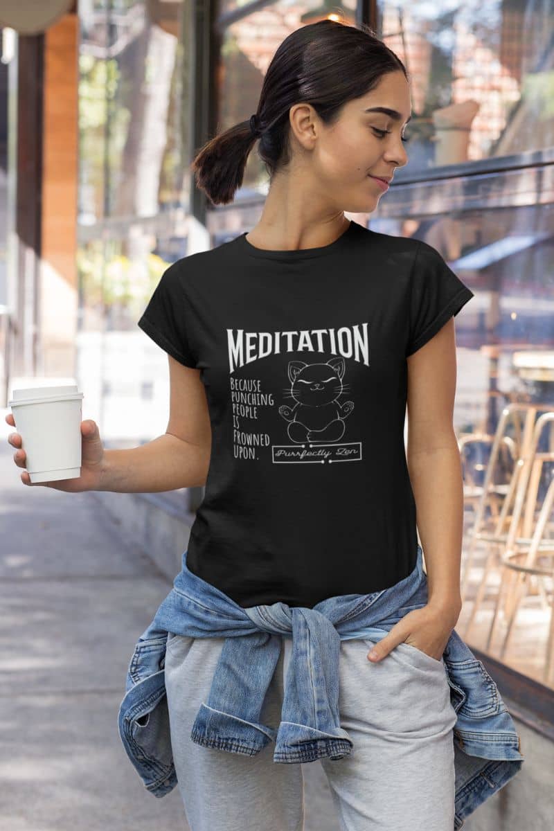Meditation T-shirt: because punching people is frowned upon with a girl standing posing with one hand holding a cup of coffee and the other hand in her pocket