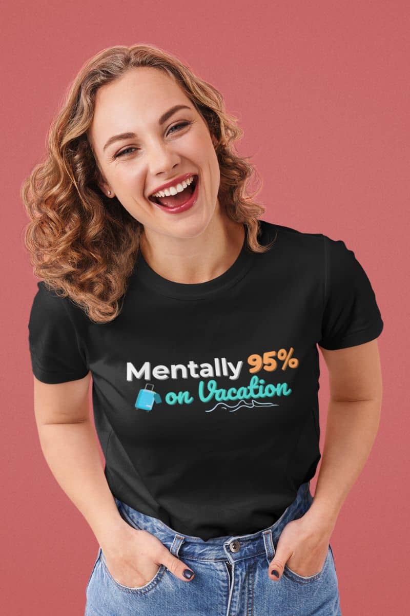 Mentally on vacation T-Shirt with a person wearing a black t-shirt with 'Mentally 95% on Vacation' text and smiling against a pink background