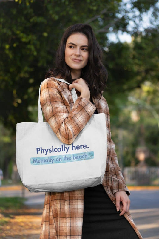 Mentally on the beach tote bag with a woman holding a tote bag with text outdoors