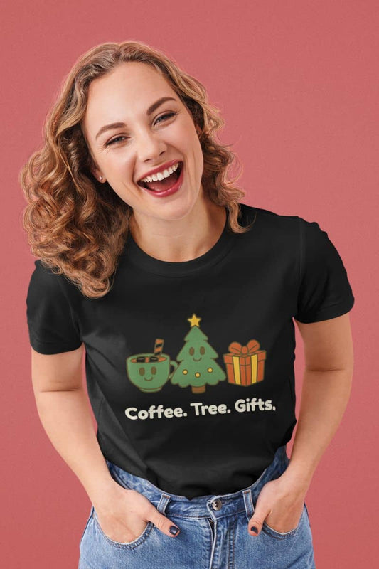 Minimalist holiday icon shirt with a woman wearing a black t-shirt with Christmas-themed graphics and text 'Coffee. Tree. Gifts.' on a pink background