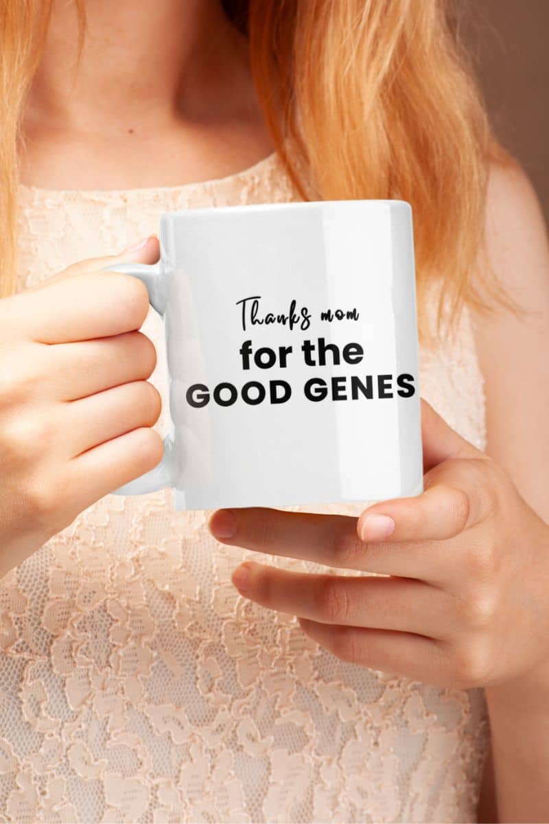 Mom coffee mug with a person holding a white mug with text 'Thanks mom for the good genes'.