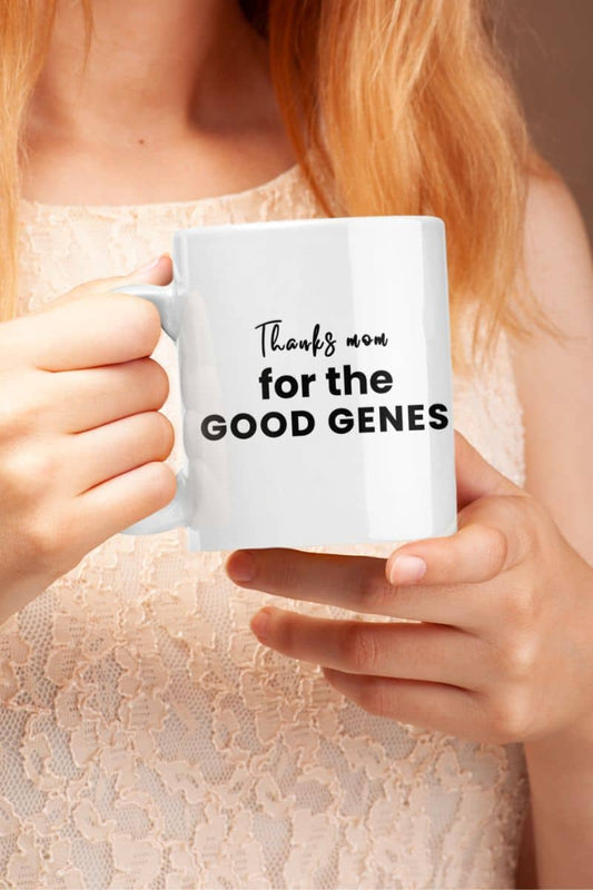 Mom coffee mug with a person holding a white mug with text 'Thanks mom for the good genes'.