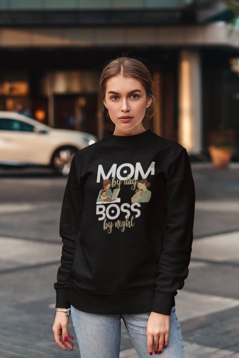 Mother's day sweatshirt with a woman wearing a black sweatshirt with text and images, standing on a street.