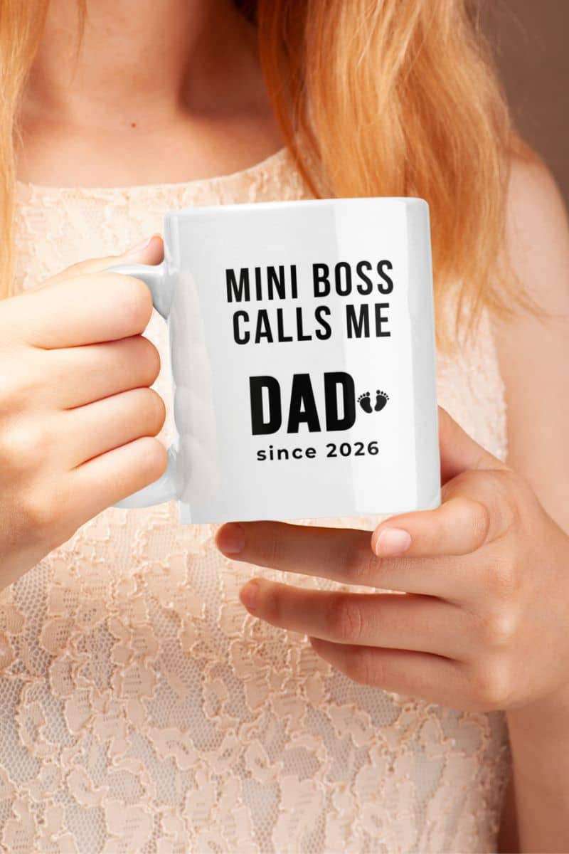 New dad mug with a person holding a mug with text 'Mini Boss Calls Me Dad since 2026' 