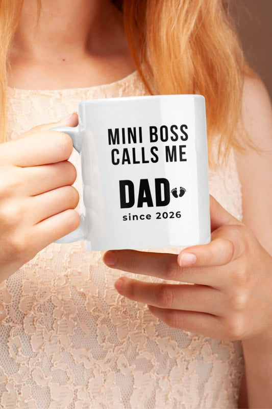 New dad mug with a person holding a mug with text 'Mini Boss Calls Me Dad since 2026' 