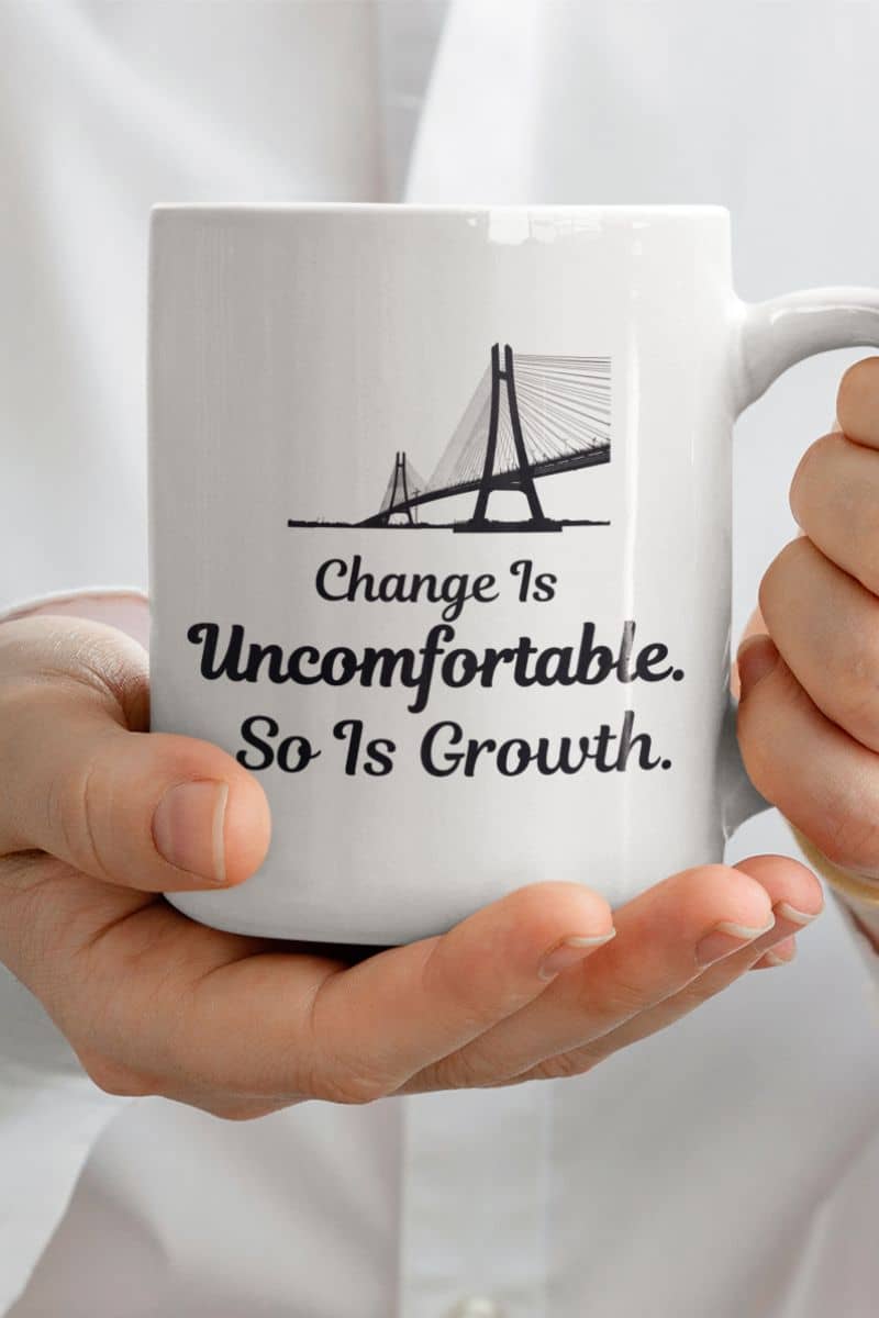 Positive mindset mug with a white mug with motivational quote held by hands against a white background