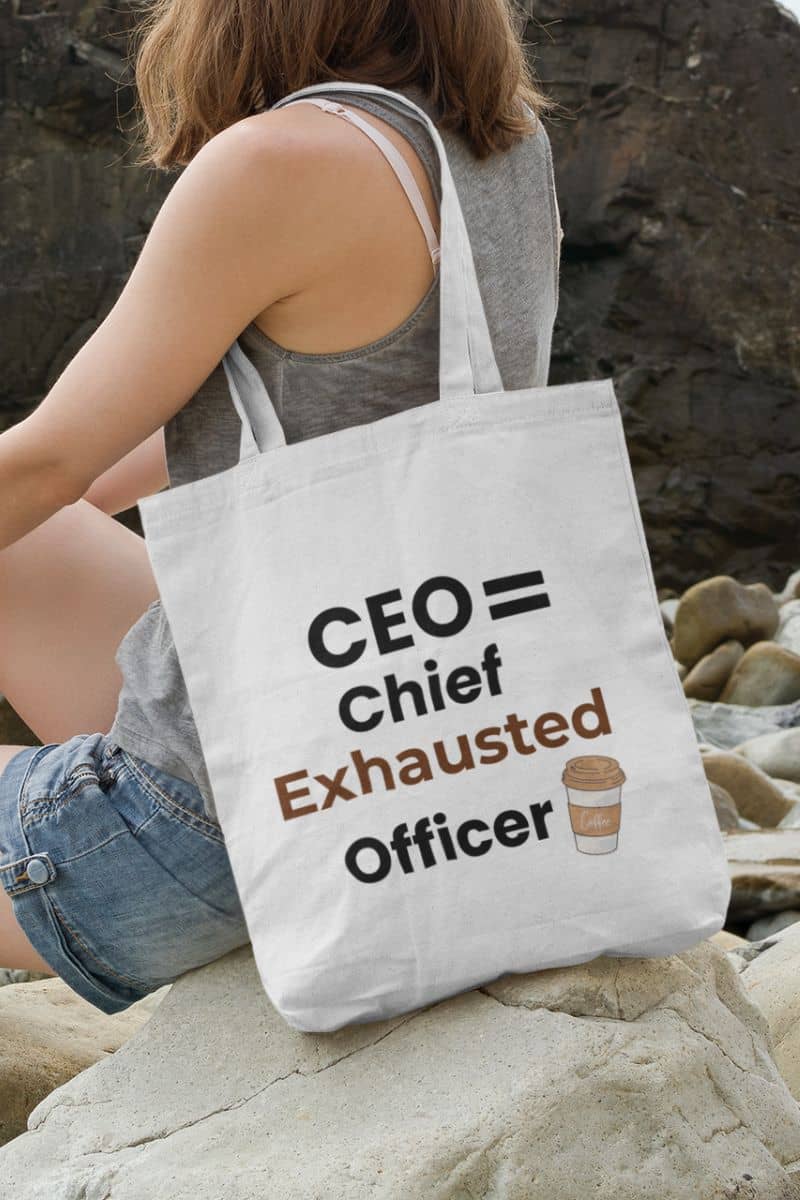 Productivity gift bag with a person sitting on rocks with a tote bag that says 'CEO = Chief Exhausted Officer' with a coffee cup icon.