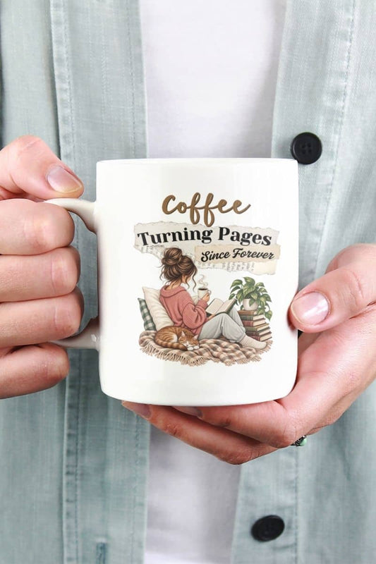 Reading coffee mug with a person holding a white ceramic coffee mug featuring the text 'Coffee Turning Pages Since Forever'. 