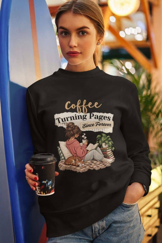 Reading sweatshirts with a woman wearing a black crewneck sweatshirt featuring the text 'Coffee Turning Pages Since Forever'