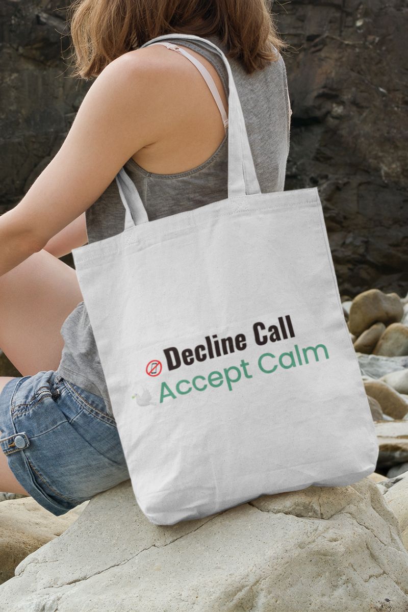Relaxation gift bag with a person sitting on rocks with a tote bag featuring 'Decline Call Accept Calm' text.