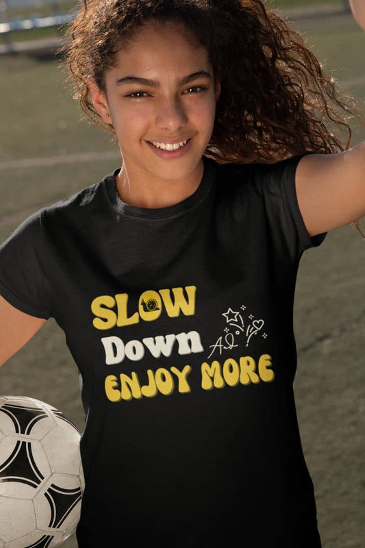 Relaxed fit graphic tee with a young girl holding a ball in the soccer field