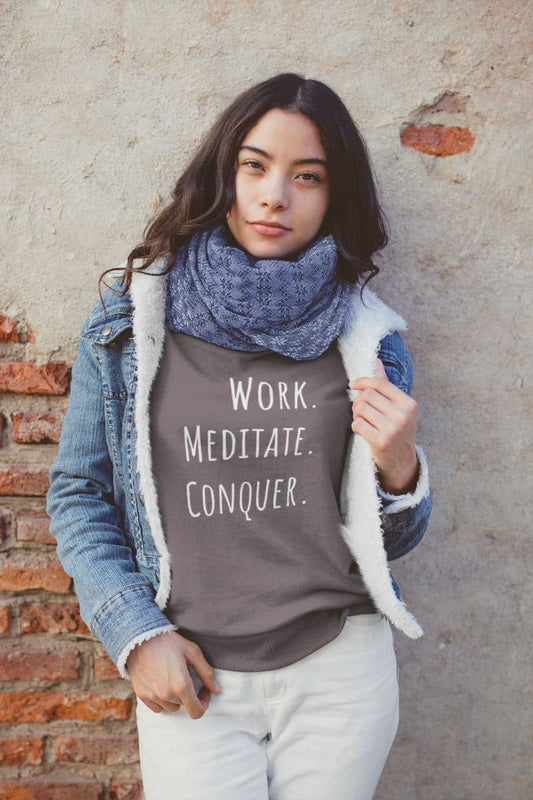 Relaxed fit meditation sweatshirt with a girl leaning against the wall posing
