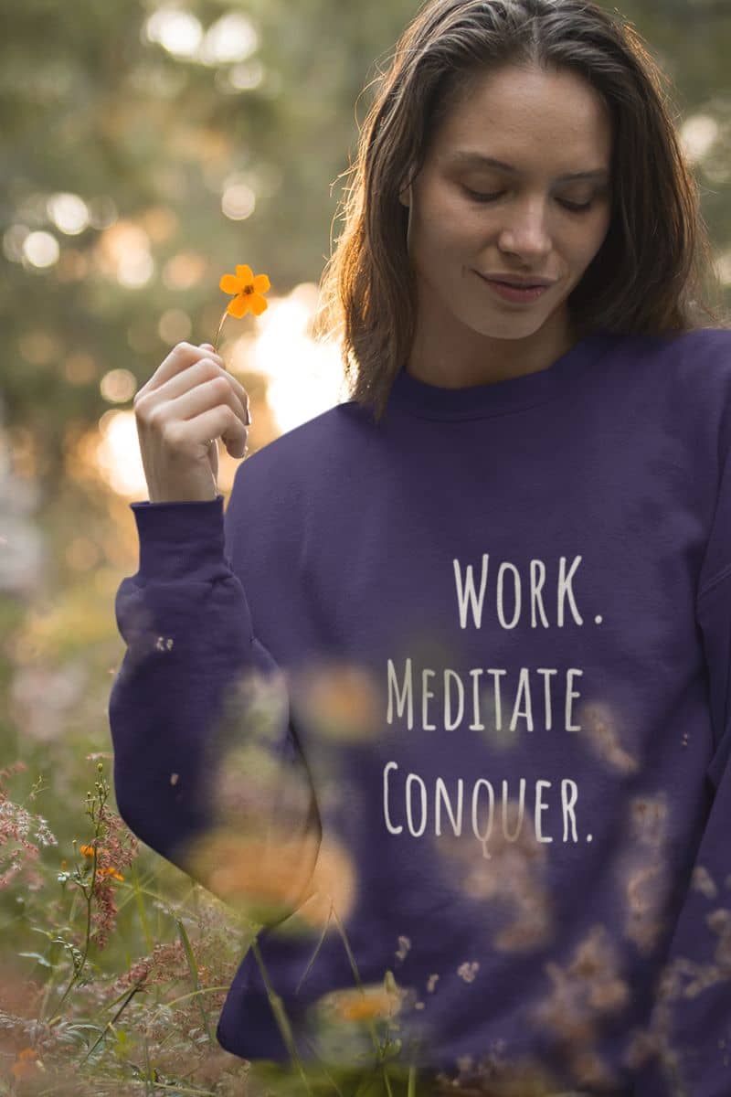 Relaxed fit meditation sweatshirt with a girl posing with a wildflower in the forest