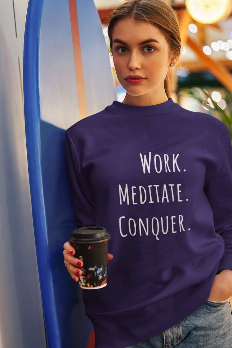 Relaxed fit meditation sweatshirt with a beautiful girl holding a cup of coffee posing next to the boards