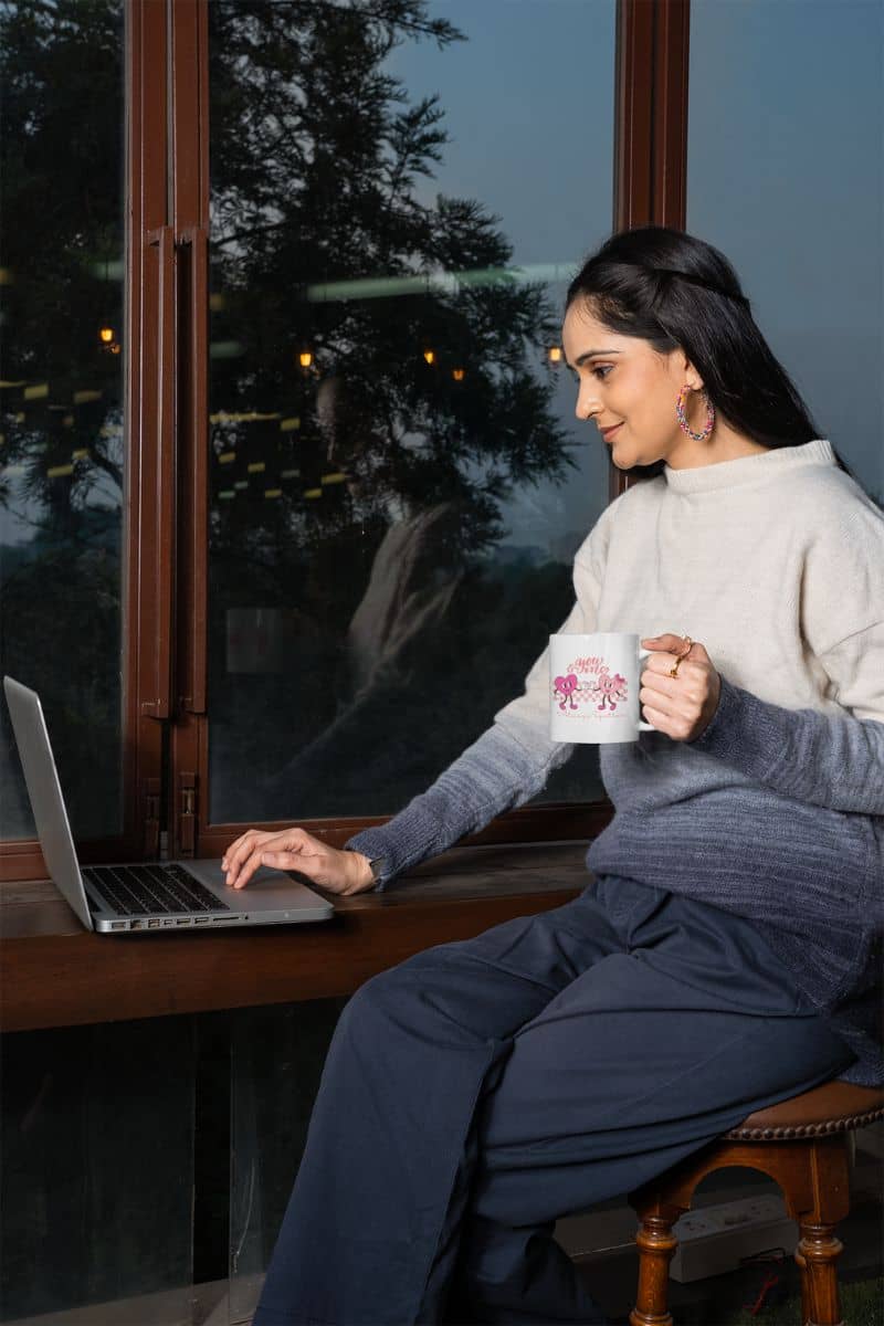 Retro Valentine mug with a girl sitting working by the window and controlling the laptop on the table