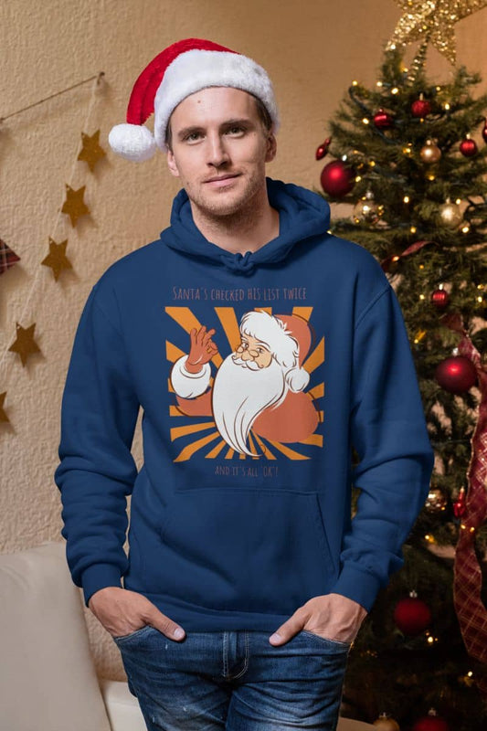 Santa's Checked His List Twice And It's All OK Hoodie with a man posing next to a pine tree