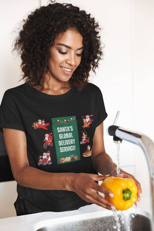 Santa's Global Delivery Service Festive Holiday T-Shirt with a girl is washing vegetables
