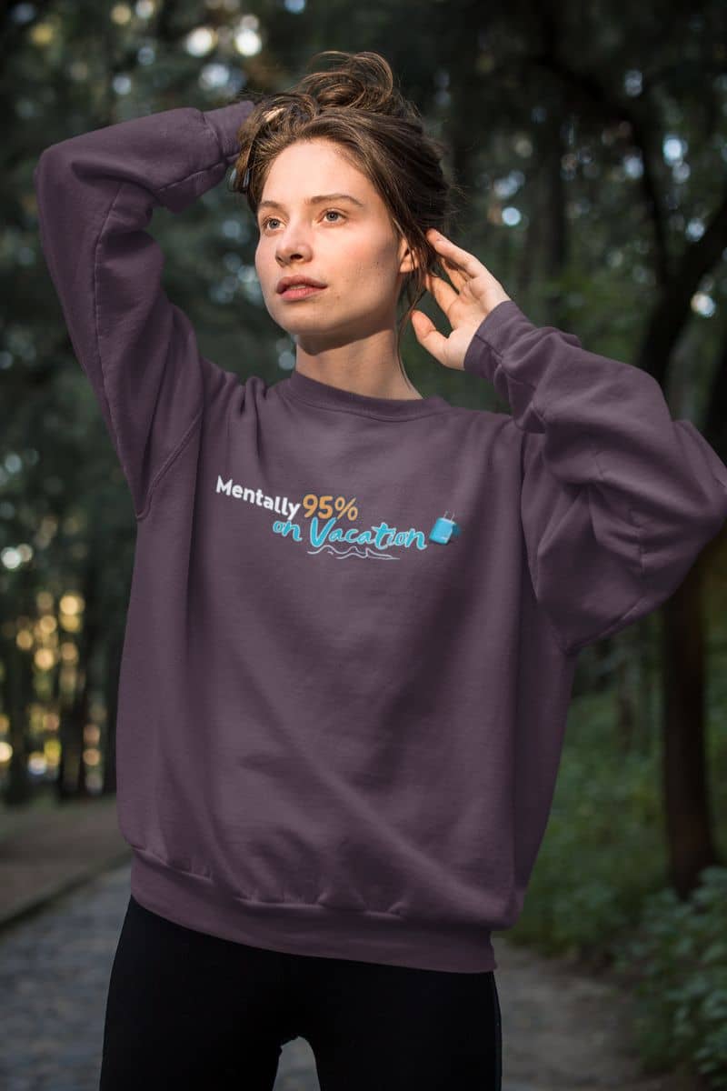 Sarcastic holiday hoodie with a person wearing a purple sweatshirt with text in a forest setting