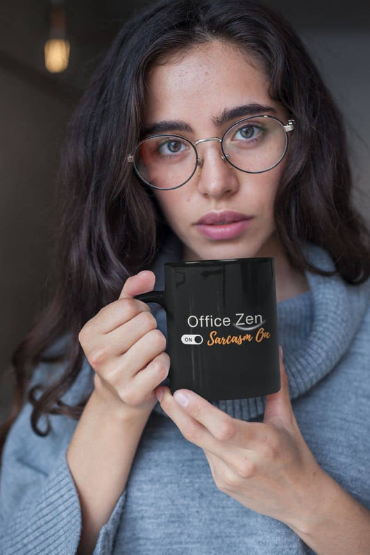 Sarcastic mindfulness mug with a person holding a mug with 'Office Zen' text, wearing glasses and a gray sweater.