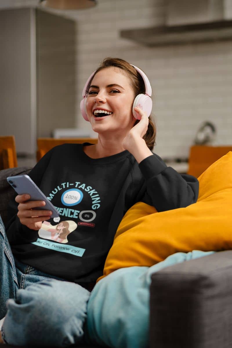 work-mode-sweatshirt with a girl sitting on the sofa listening to music and laughing happily