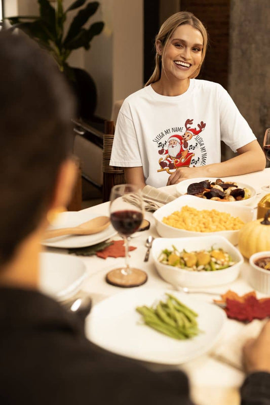 Sleigh My Name, Sleigh My Name T-Shirt. A girl is happily talking at the dining table.