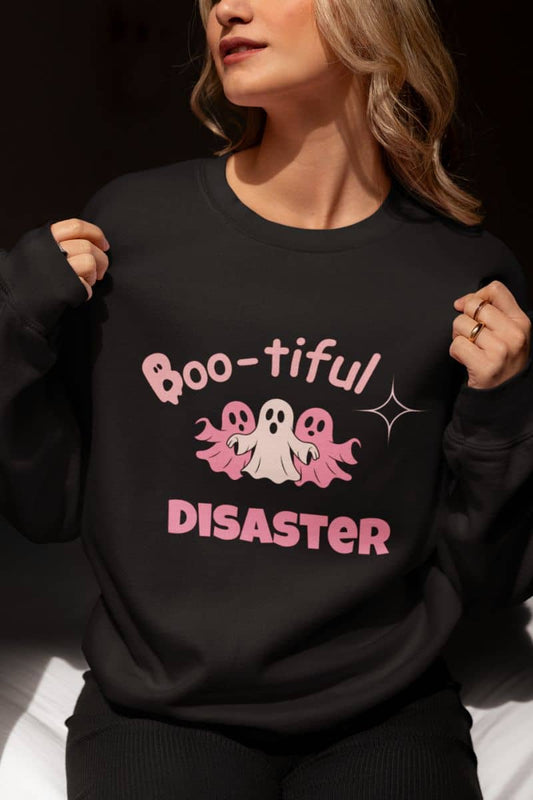 Spooky season sweatshirt with a person wearing a black sweatshirt with 'Boo-tiful Disaster' text and ghost graphics.