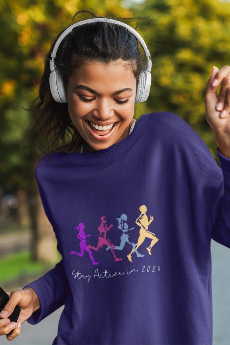 Stay Active in 2025 Sweatshirt with a girl wearing headphones and dancing to music on the street