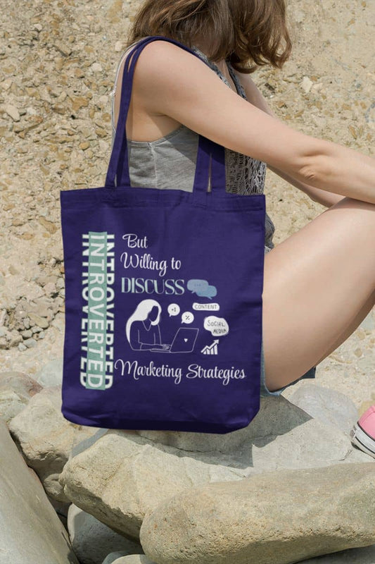 Strategic introvert tote with a girl sitting on the rocks at the beach