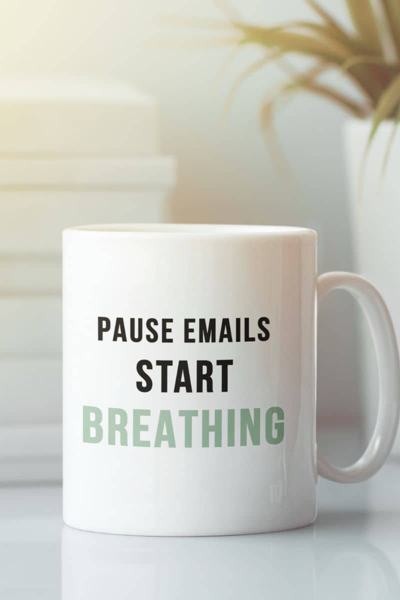 Stress relief mug with a white mug with text 'Pause Emails, Start Breathing' on a blurred background