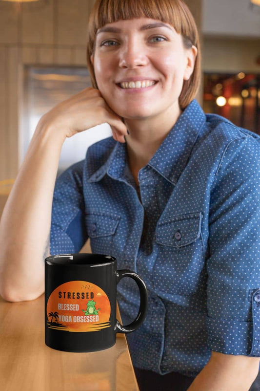 Stressed, blessed, yoga obsessed mug with the girl sitting with her chin on her hands and smiling brightly