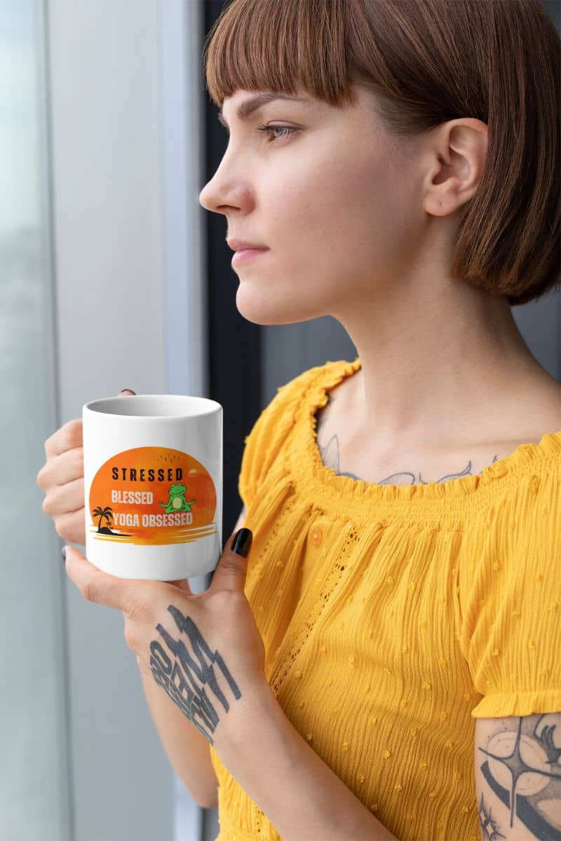 Stressed, blessed, yoga obsessed mug with the girl holding a cup and looking into the distance