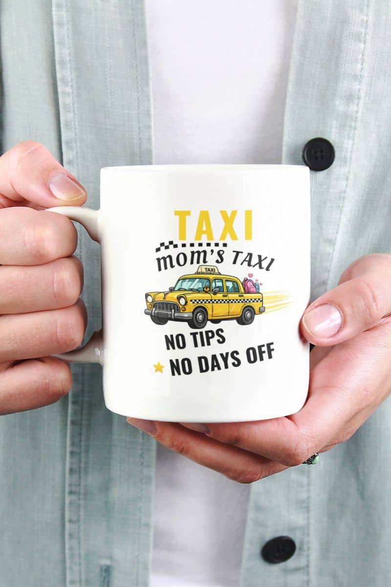 Tired mom coffee mug with a person holding a mug with text 'Taxi, Mom’s Taxi – No tips, no days off'