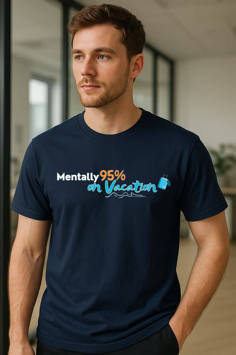 Tropical escape shirt with a man wearing a navy blue t-shirt with text 'Mentally 95% on Vacation' in an office setting