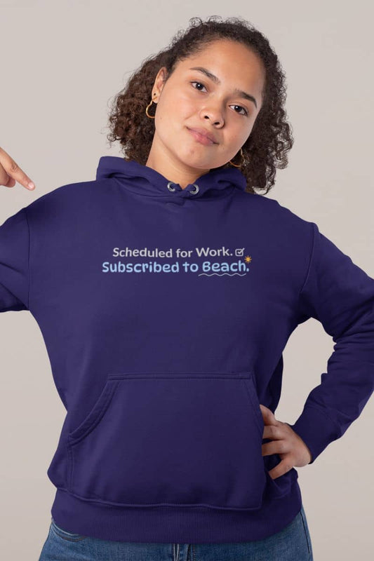 Vacation hoodie with a person in a purple hoodie with text 'Scheduled for Work. Subscribed to Beach', standing against a plain background