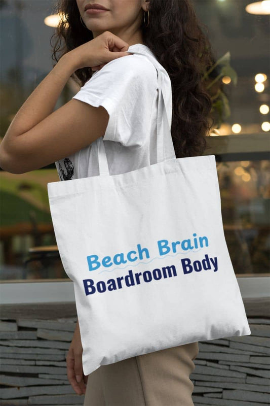 Work beach vibes tote bag with person holding a white tote bag with 'Beach Brain Boardroom Body' text.