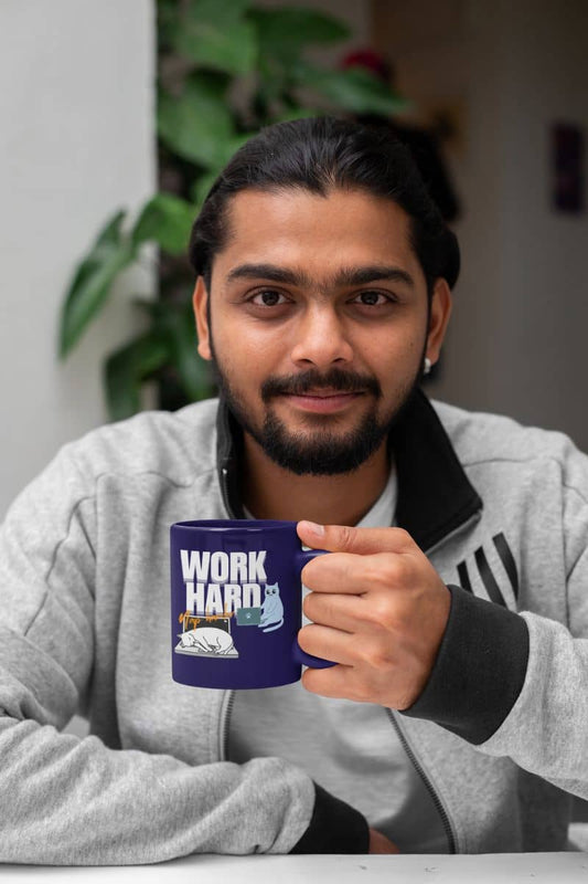 Work hard, nap harder mug with a guy in a jacket holding a cup on the desk