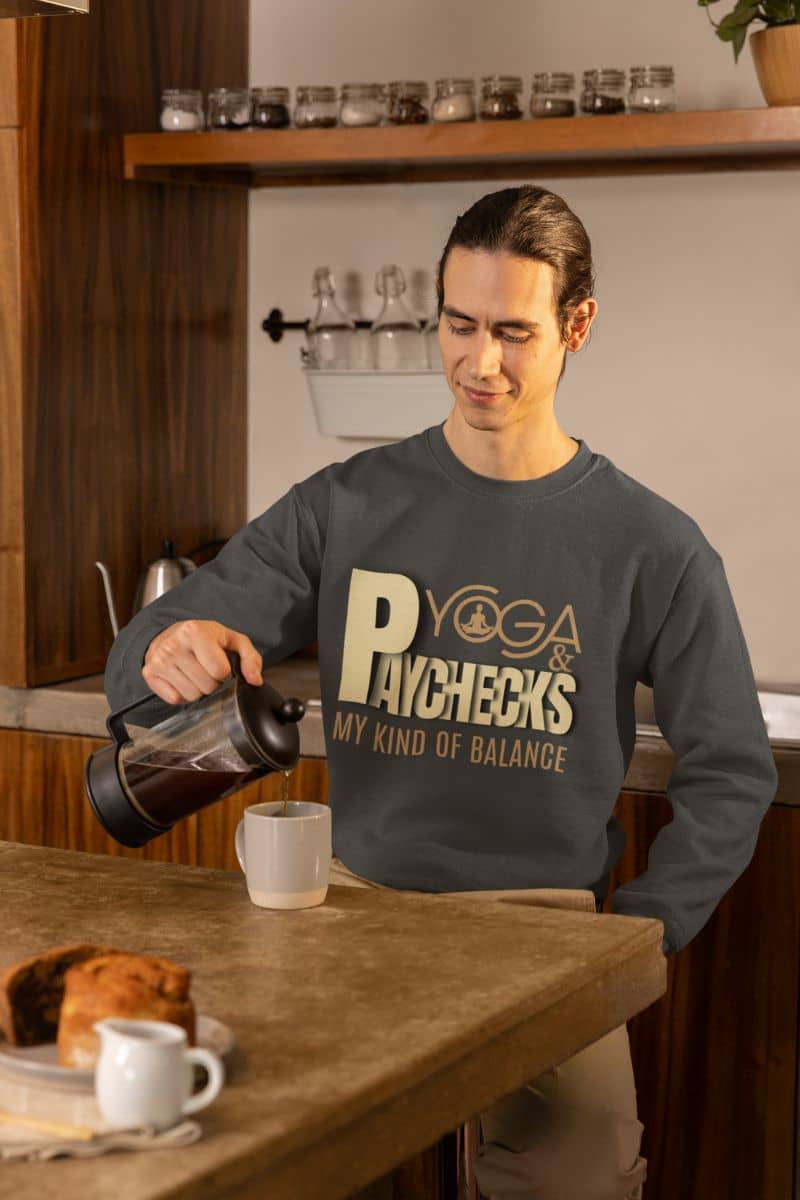 Yoga and paychecks sweatshirt with a person pouring coffee and cups in the kitchen
