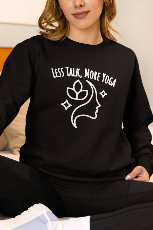 Yoga mindfulness sweatshirt with a person wearing a black sweatshirt with 'LESS TALK, MORE YOGA' text and design.