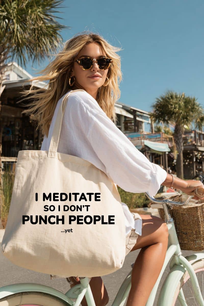 anti social tote bag with a woman on a bike with a tote bag featuring the text 'I Meditate So I Don’t Punch People...yet', outdoor setting