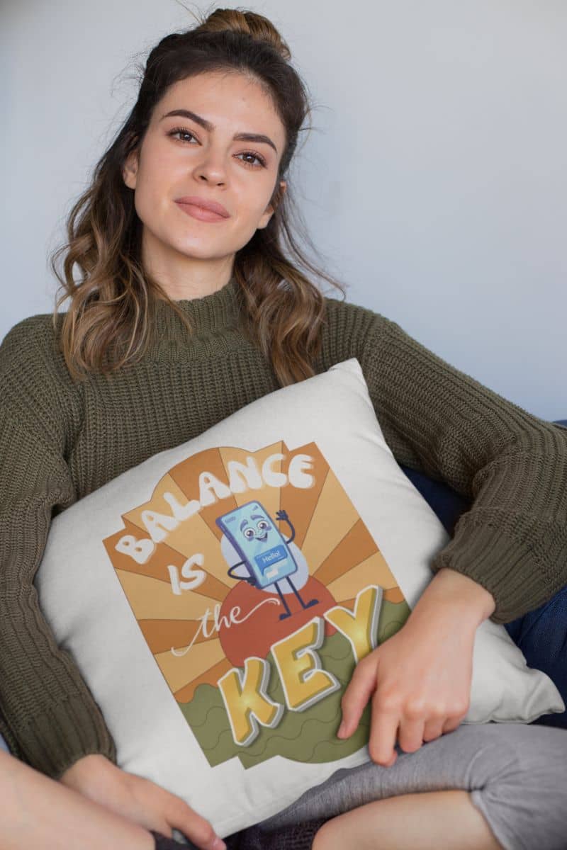 balance quote pillow with a woman holding a pillow with 'Balance is the Key' design