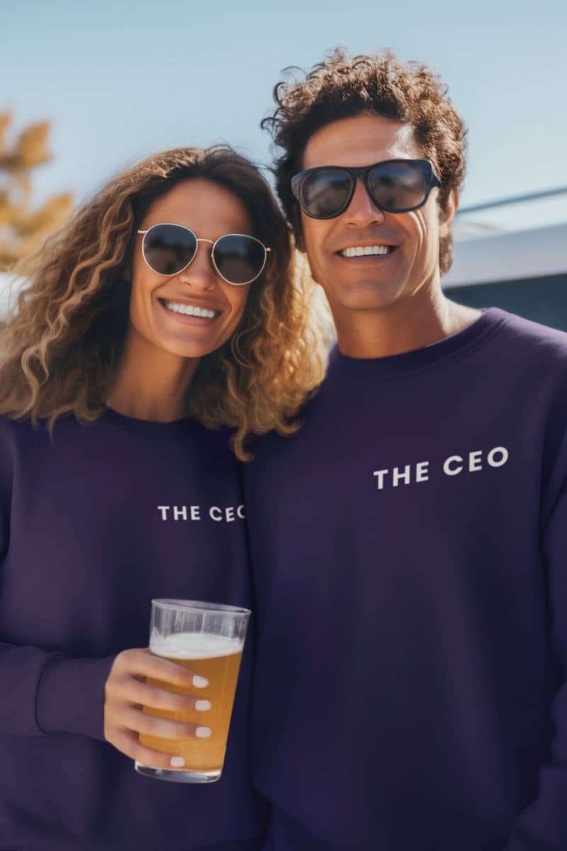 best couple sweatshirt-gift with two people wearing 'THE CEO' sweatshirts, one holding a beer, outdoors.