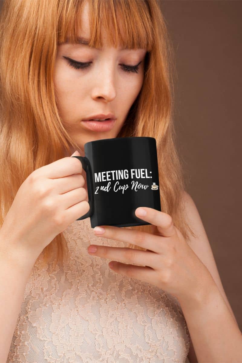 bold coffee quote mug with a woman holding a black mug with text against a brown background