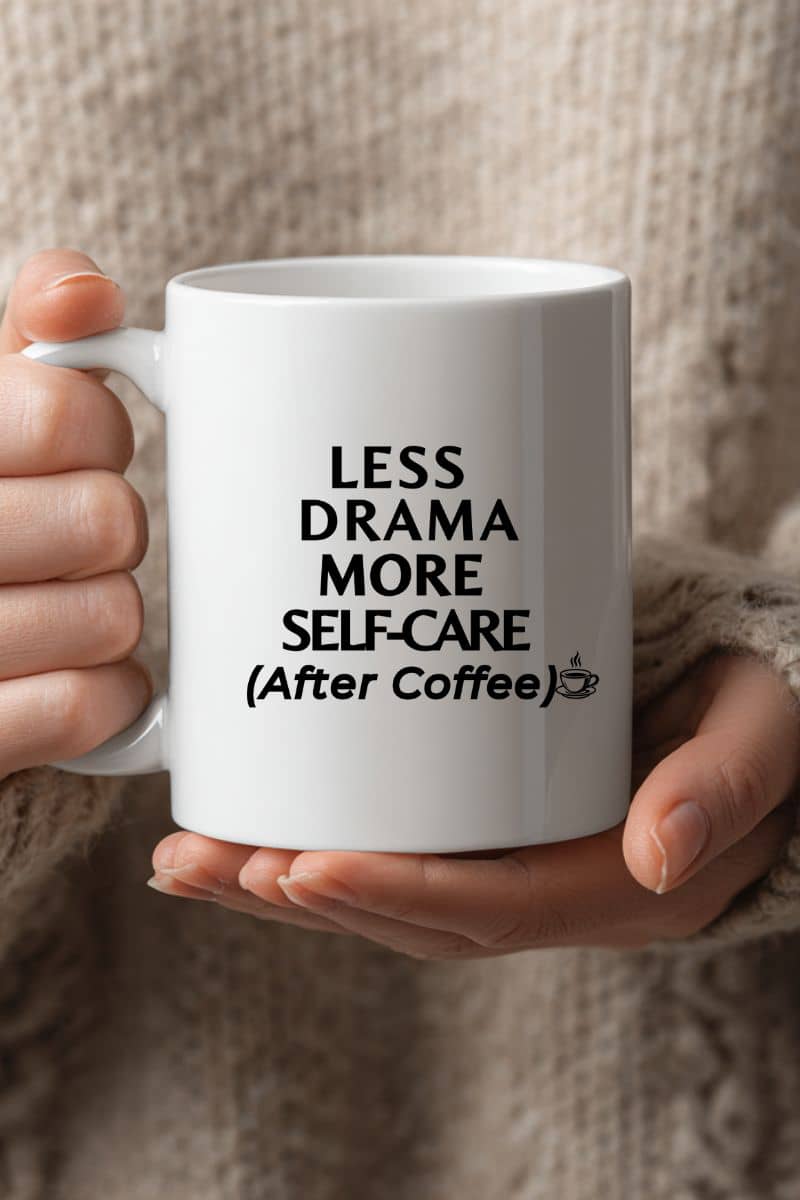 burnout coffee mug with a white mug with text 'Less Drama, More Self-Care (After Coffee)' held by a person.