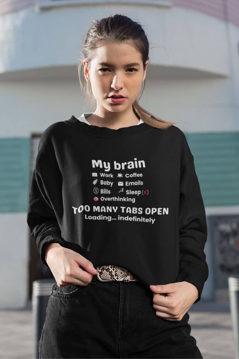 burnout humor sweatshirt with a woman wearing a sweatshirt featuring the text 'My Brain Has Too Many Tabs Open', outdoors
