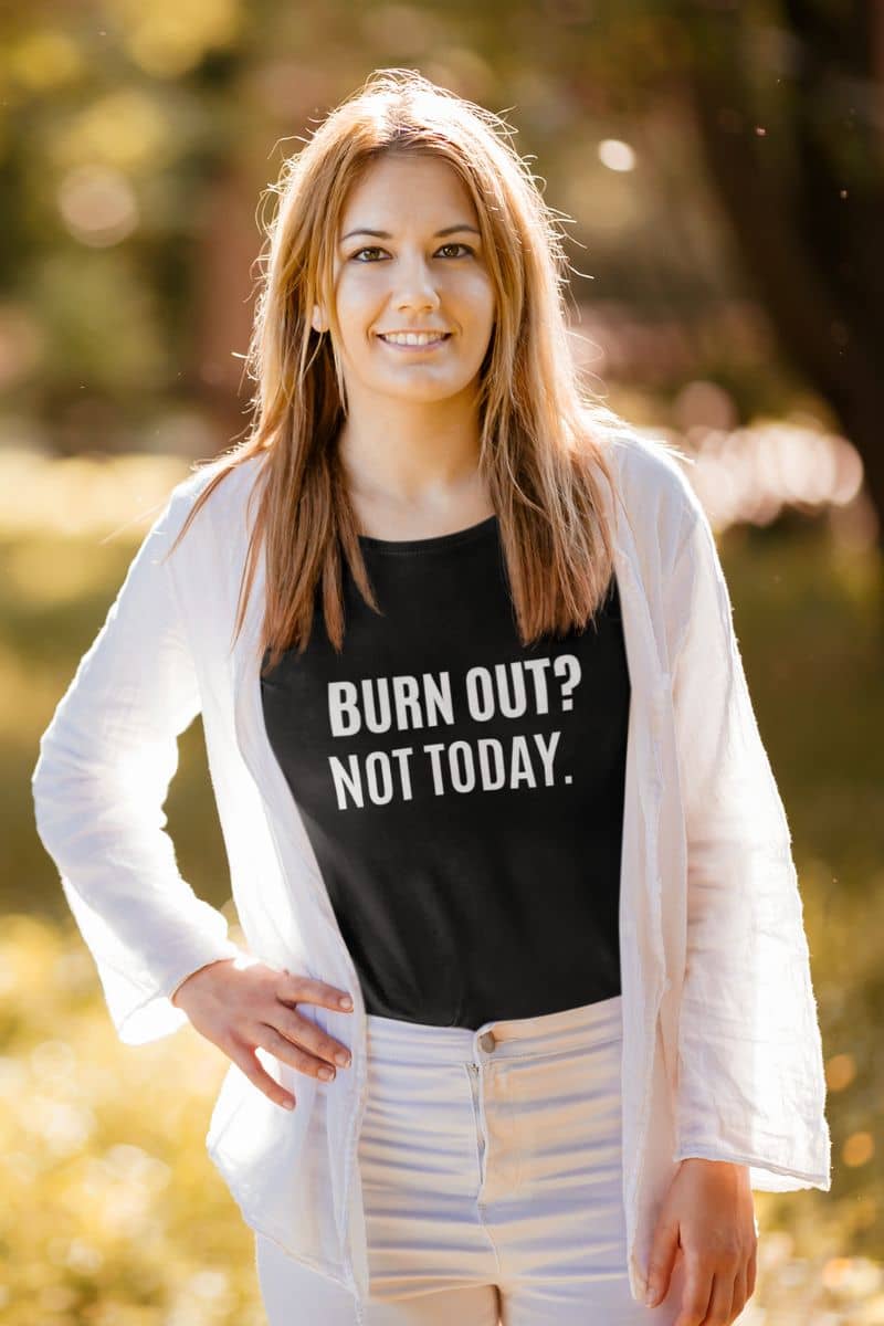 burnout recovery shirt with a woman wearing a black t-shirt with 'BURN OUT? NOT TODAY.' text, standing outdoors.