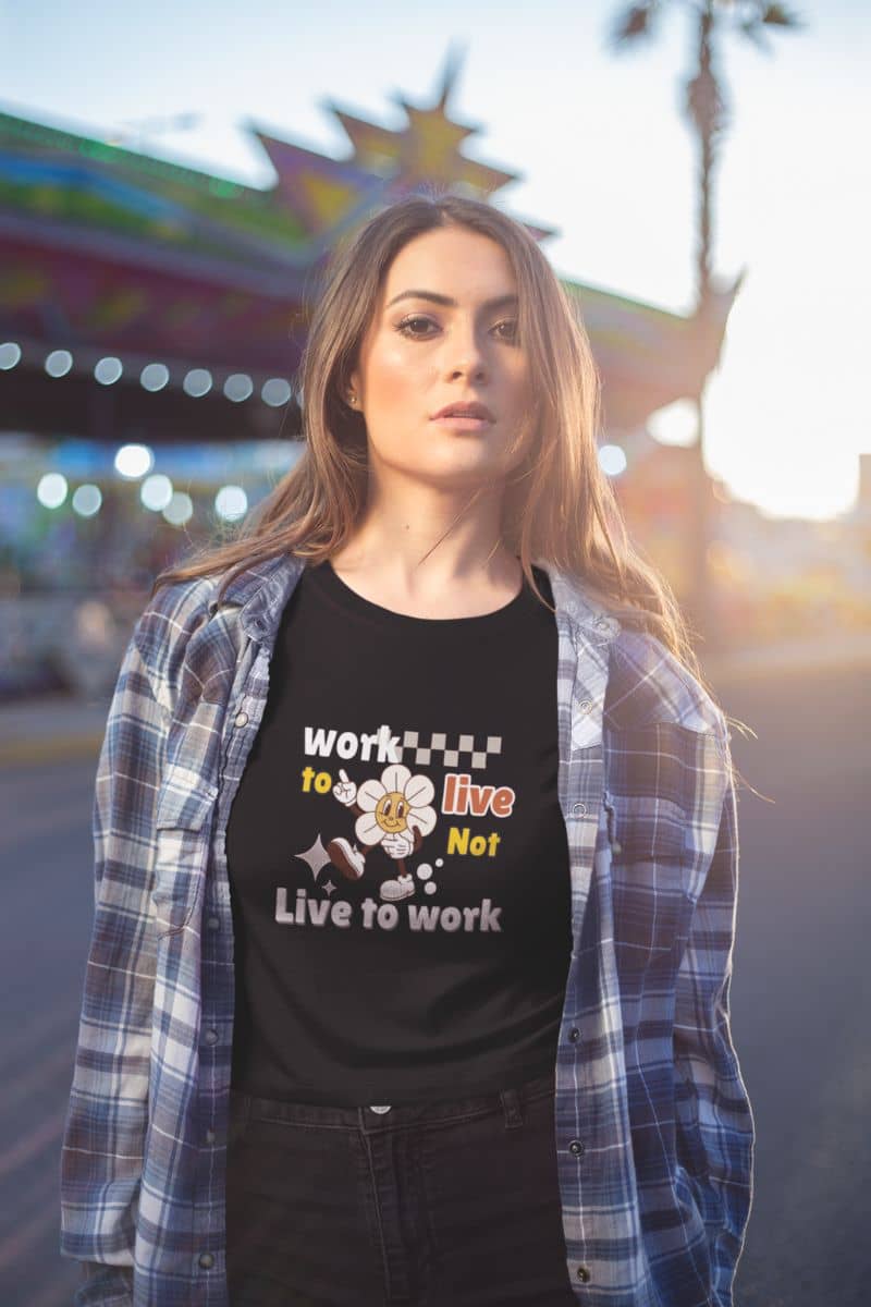 burnout recovery shirt with a woman wearing a black t-shirt with text 'Work to Live, Not Live to Work' in an outdoor setting