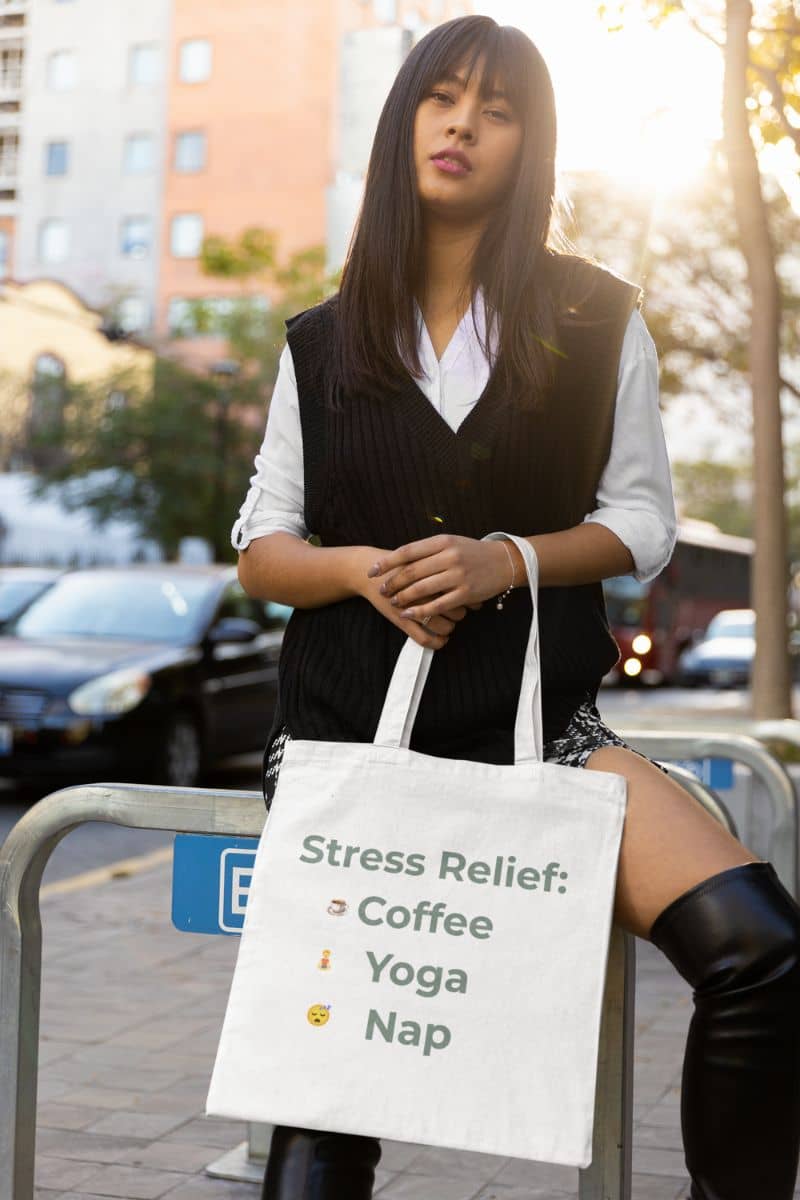 burnout recovery tote with a woman holding a tote bag with 'Stress Relief' items on a city street.