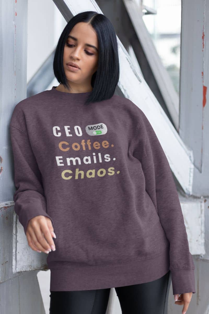 A business casual pullover with a woman wearing a sweatshirt with text 'CEO Mode: Coffee. Emails. Chaos.'