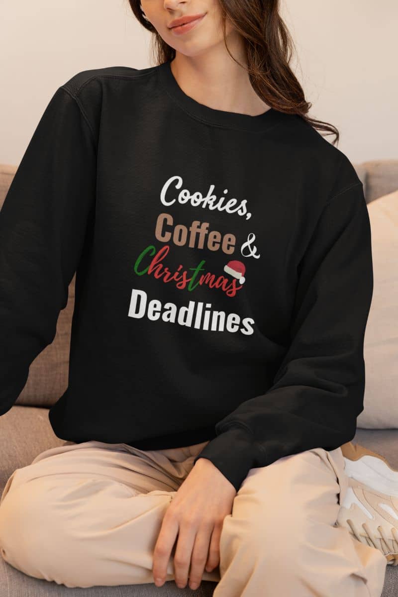 caffeine lover sweater with a person wearing a black sweatshirt with 'Cookies, Coffee & Christmas Deadlines' text.