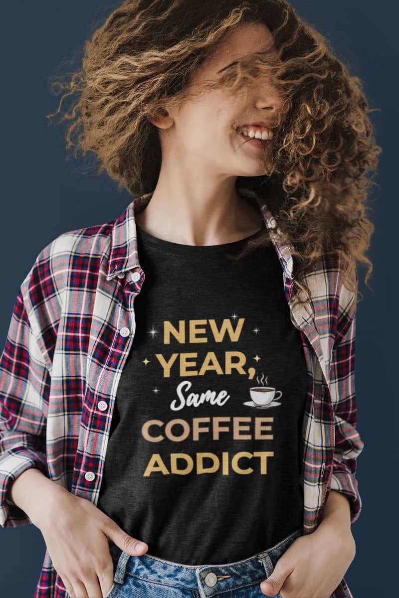 caffeine lover tee with a person wearing a black t-shirt with 'New Year, Same Coffee Addict' text and a coffee cup graphic.